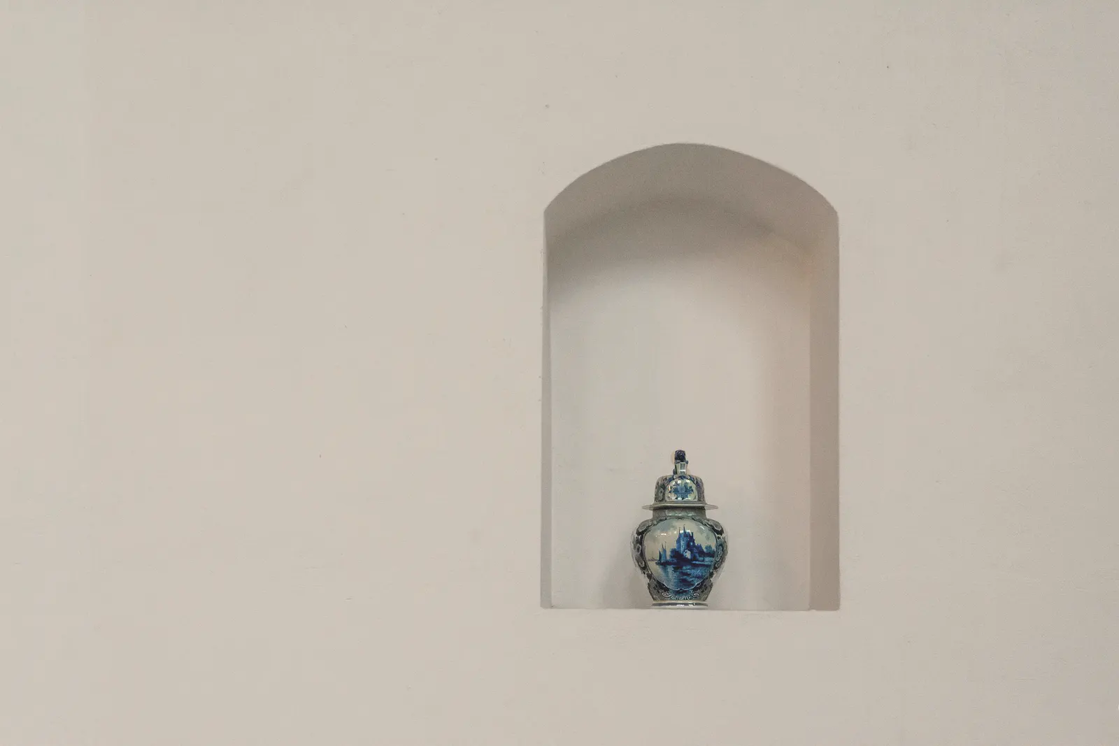 Arched wall niche with a vase